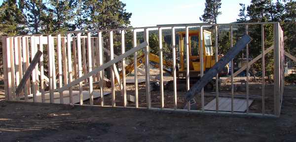 Three framed garage walls standing on the block foundation with temporary bracing