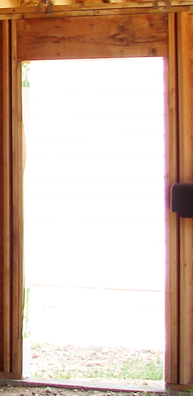 Framed pedestrian door opening showing king studs, jack studs and header with the sill plate cut away